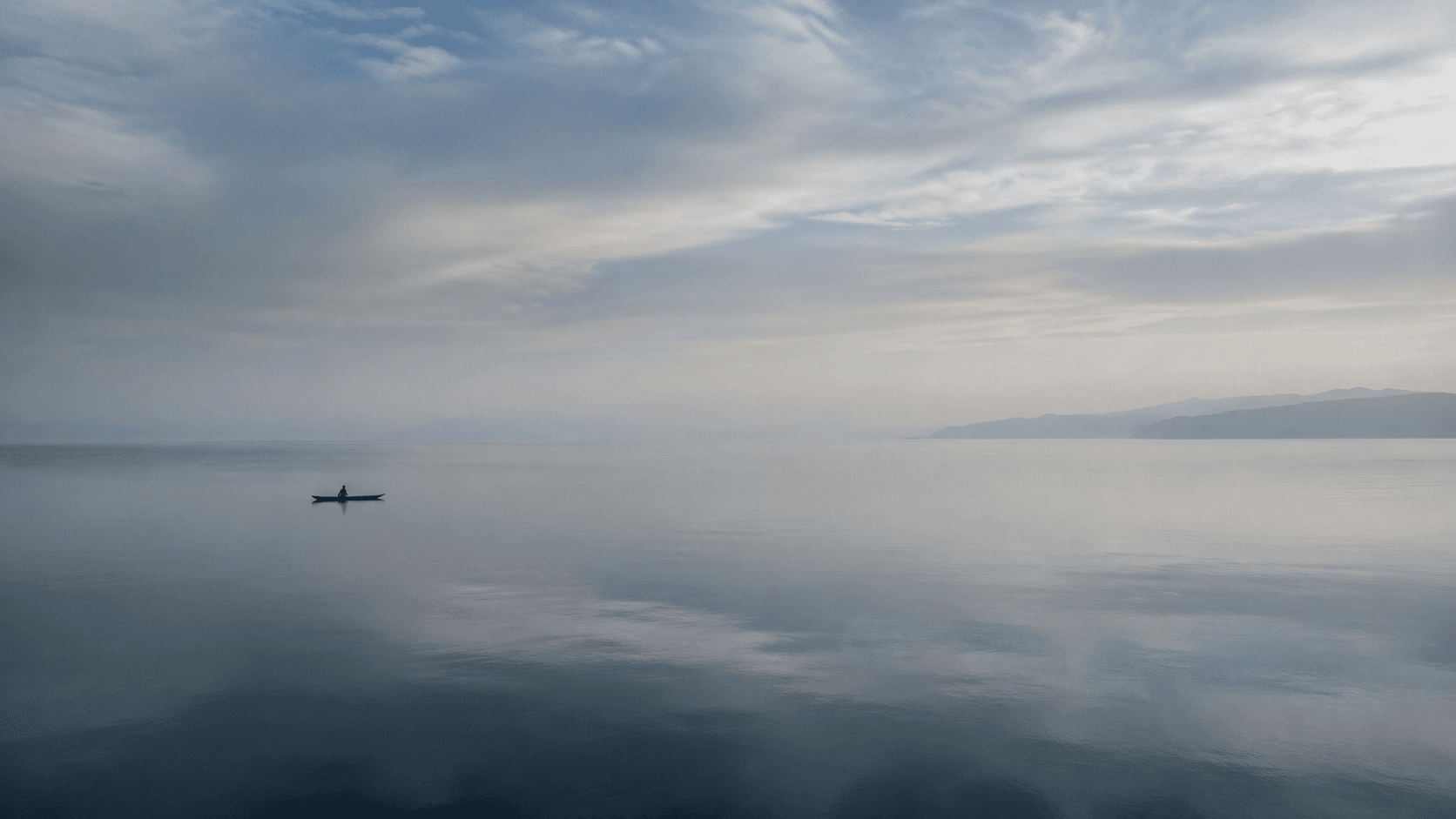 Dawn light spreading across the vast still surface of Lake Malawi
